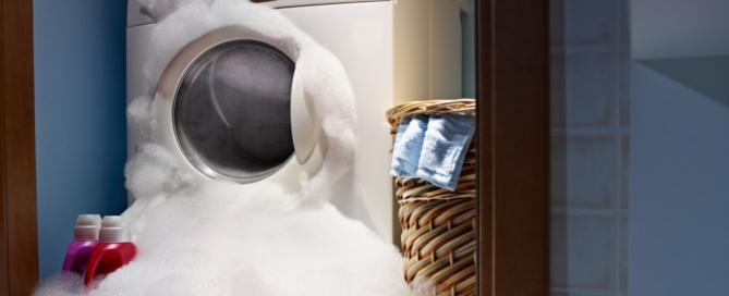 Washing machine overflowing with suds