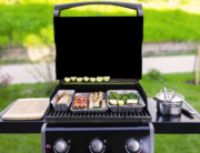 gas grill with vegetables and sausages