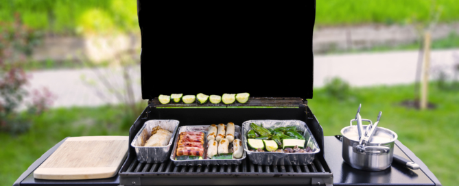 gas grill with vegetables and sausages